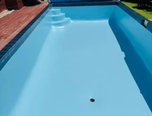 Completed swimming pool painting with a bright, clean, renewed surface